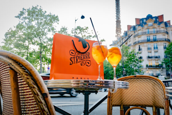 St Pierre Bags In Paris with Aperol Spritz cocktails on a table