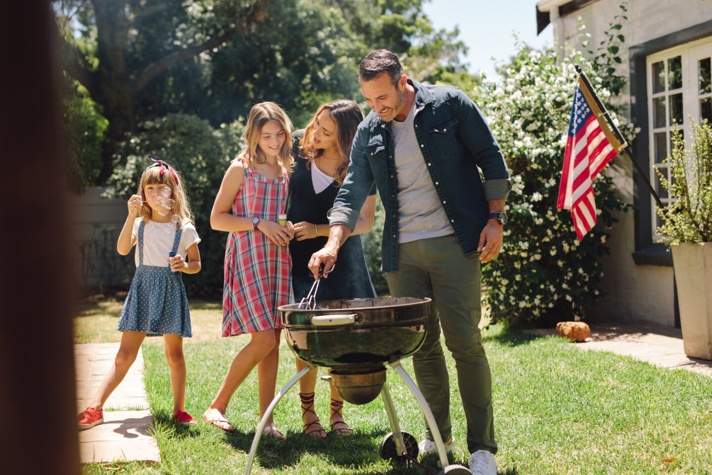 Memorial Day Celebration Outdoor Barbecue BBQ Grill Family grilling together in a garden